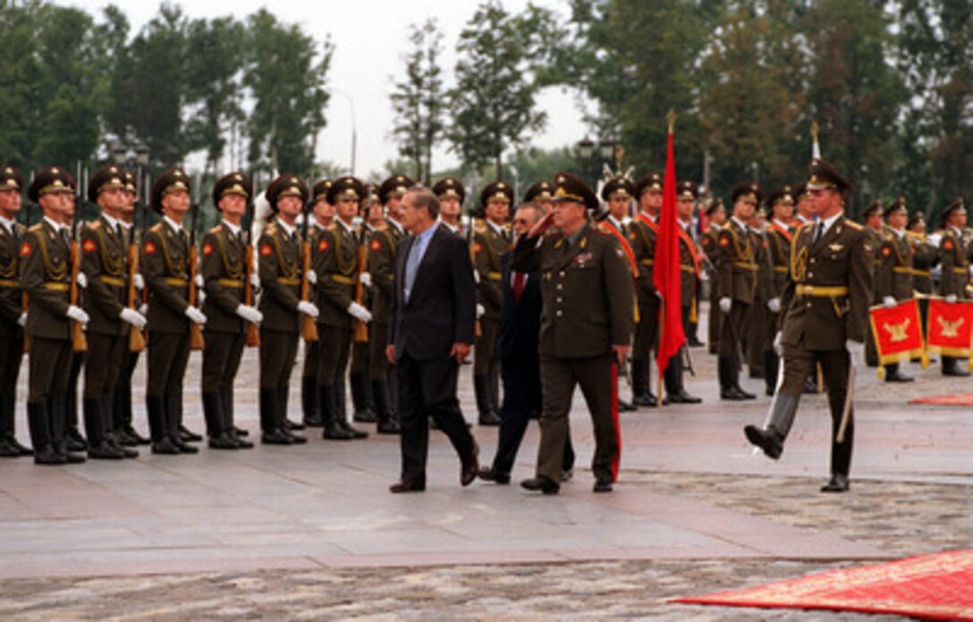 Secretary of Defense Donald H. Rumsfeld (left) inspects the troops at Victory Park during an armed forces honors ceremony welcoming him to Moscow, Russia, on Aug. 11, 2001. Rumsfeld is escorted by Military Commandant of Moscow General-Maj. Aleksandr N. Denisov (right). Rumsfeld is in Russia to meet with defense leaders and discuss the Anti-Ballistic Missile Treaty. 