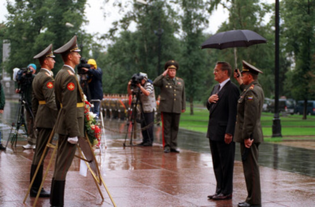 Secretary of Defense Donald H. Rumsfeld salutes while the U.S. national anthem is played during a wreath laying ceremony at the Tomb of the Unknown outside the Kremlin wall in Moscow on Aug. 13, 2001. Rumsfeld is in Russia to meet with defense leaders and discuss the Anti-Ballistic Missile Treaty. 