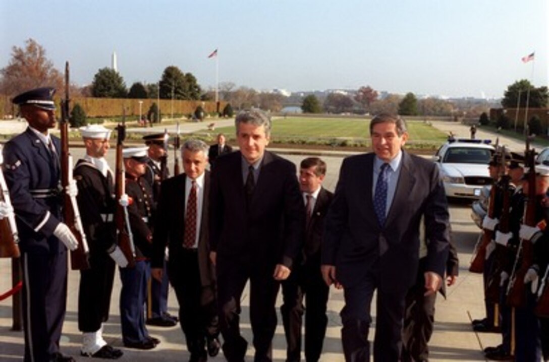 Albanian Minister of Defense Pandeli Majko (left) is escorted through an honor cordon and into the Pentagon by Deputy Secretary of Defense Paul Wolfowitz (right) on Nov. 19, 2001. The two leaders will meet to discuss issues of mutual interest to both nations. 