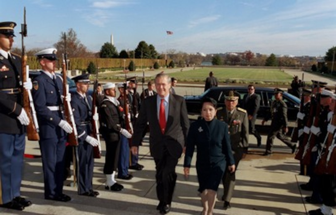Secretary of Defense Donald H. Rumsfeld (left) escorts Philippines President Gloria Macapagal-Arroyo (right) through an honor cordon and into the Pentagon on Nov. 20, 2001. The two leaders will meet to discuss issues of mutual interest to both nations. 