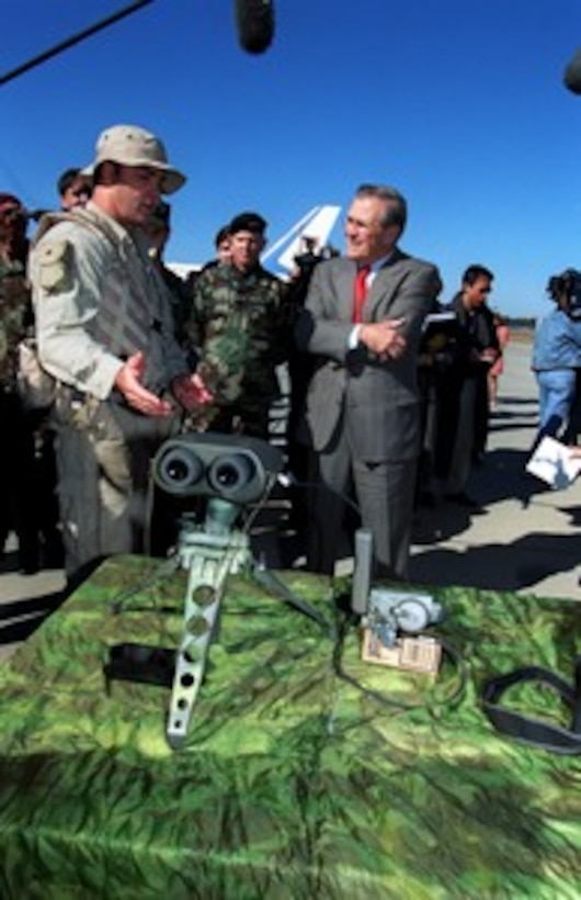 A Navy SEAL explains tactical observation equipment to Secretary of Defense Donald H. Rumsfeld during his visit to Pope Air Force Base, N.C., on Nov. 21, 2001. Rumsfeld is visiting Pope and Fort Bragg to receive briefings and demonstrations on the capabilities of U.S. Special Forces made up of Army Rangers and Special Forces, Navy SEAL teams and Air Force Combat Control Teams. 