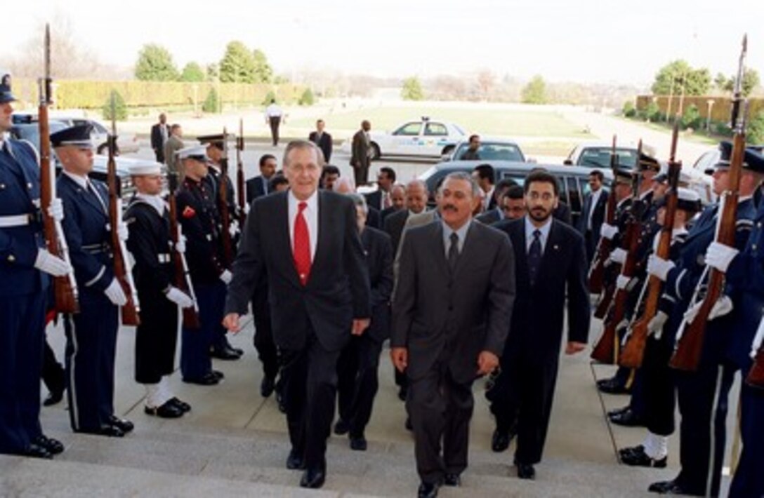 Secretary of Defense Donald H. Rumsfeld (left) escorts President Ali Abdallah Salih (right), of Yemen, through an honor cordon and into the Pentagon on Nov. 26, 2001. The two men will meet to discuss a range of security issues of interest to both nations. 