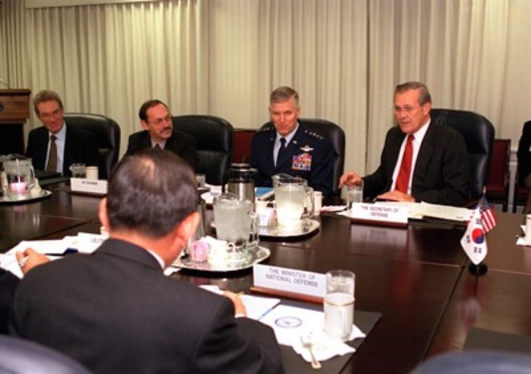 Secretary of Defense Donald H. Rumsfeld (right) begins talks with South Korean Minister of National Defense Kim Dong Shin (foreground) as the annual U.S.--Republic of Korea Security Consultative Meeting gets underway at the Pentagon on Nov. 15, 2001. Assistant Secretary of Defense for International Security Affairs Peter Rodman (left), Under Secretary of Defense (Comptroller) Dov Zakheim, and Chairman of the Joint Chiefs of Staff Gen. Richard B. Myers, U.S. Air Force joined in the talks which provide an opportunity for the two nations to review their security relationships and propose modifications, as necessary, to deal with changing world conditions. 
