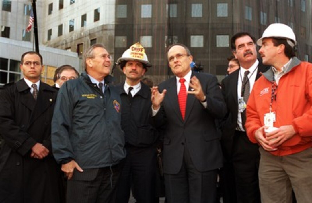 New York City Mayor Rudolph Giuliani (3rd from right) describes the clean-up operation at the site of the World Trade Center terrorist attack in lower Manhattan to Secretary of Defense Donald H. Rumsfeld (2nd from left) on Nov. 14, 2001. Rumsfeld is visiting the site of the Sept. 11th disaster to speak to Giuliani, officials from the N.Y. Fire Department and the Office of Emergency Management. 