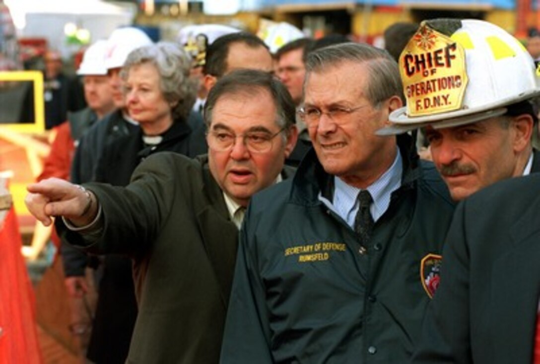 Richard Sherier (left), director of the Office of Emergency Management, describes the clean-up operation at the site of the World Trade Center terrorist attack in lower Manhattan to Secretary of Defense Donald H. Rumsfeld (center) on Nov. 14, 2001. Rumsfeld is visiting the site of the Sept. 11th disaster to speak to Mayor Rudolph Giuliani, officials from the N.Y. Fire Department and the Office of Emergency Management. 