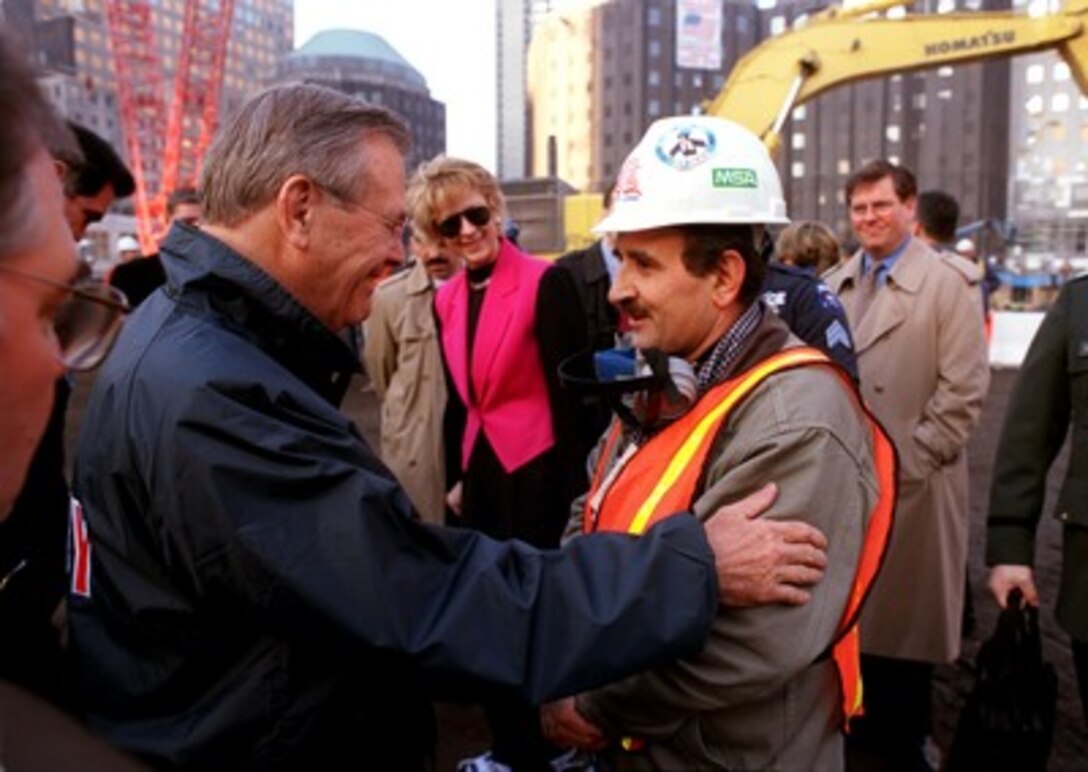 Secretary of Defense Donald H. Rumsfeld (left) talks to one of the recovery workers at the site of the World Trade Center disaster in New York City on Nov. 14, 2001. A native of Afghanistan, the worker wanted to thank Rumsfeld and the U.S. armed forces for their efforts in liberating his country from the grip of the Taliban and those associated with the al Qaeda terrorist organization. Rumsfeld is visiting the site of the Sept. 11th disaster to speak to Mayor Rudolph Giuliani, officials from the N.Y. Fire Department and the Office of Emergency Management. 