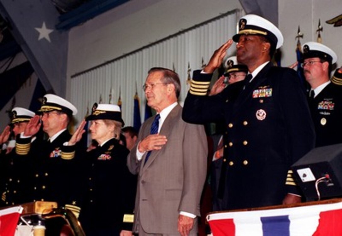 Secretary of Defense Donald H. Rumsfeld (2nd from right) and members of the official party salute during the National Anthem during a graduation ceremony at Naval Training Center Great Lakes, Great Lakes, Ill., on Nov. 16, 2001. Joining Rumsfeld on the reviewing platform are (left to right) Chief of Naval Education and Training Vice Adm. Alfred G. Harms Jr., Commander Naval Training Center Great Lakes Rear Adm. Ann E. Rondeau, and Capt. Edward W. Gantt. 
