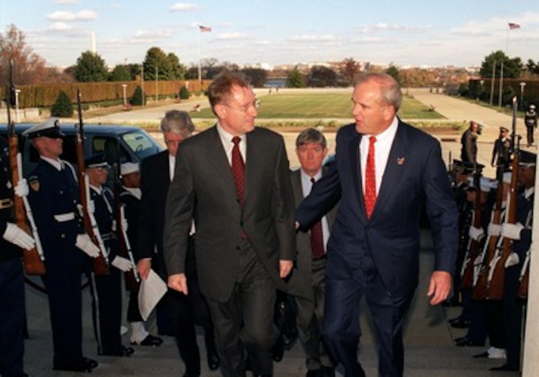 Canadian Minister of Defense Arthur Eggleton (left) is escorted by Secretary of the Army Thomas White through an honor cordon and into the Pentagon on Nov. 20, 2001, for a meeting with Secretary of Defense Donald Rumsfeld. Eggleton, White and Rumsfeld will meet to discuss a range of bilateral security issues and the war on terrorism. 