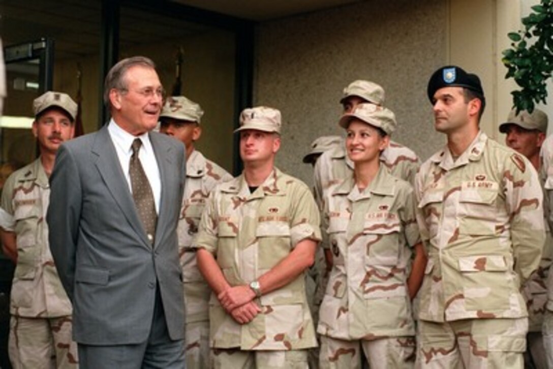 Secretary of Defense Donald H. Rumsfeld talks with military personnel at Central Command Headquarters at McDill Air Force Base, Fla., on Nov. 27, 2001. Rumsfeld is touring Central Command Headquarters and McDill Air Force Base to meet with some of the U.S. and international military personnel managing the various aspects of the ongoing military operations in and around Afghanistan. 