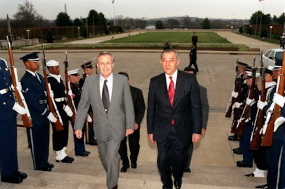Secretary of Defense Donald H. Rumsfeld (left) escorts Minister of Defense Kodir Ghulomov (right), of Uzbekistan, through an honor cordon and into the Pentagon on Nov. 30, 2001. The two defense leaders will meet to discuss a range of bilateral security issues including regional support for the war on terrorism. 