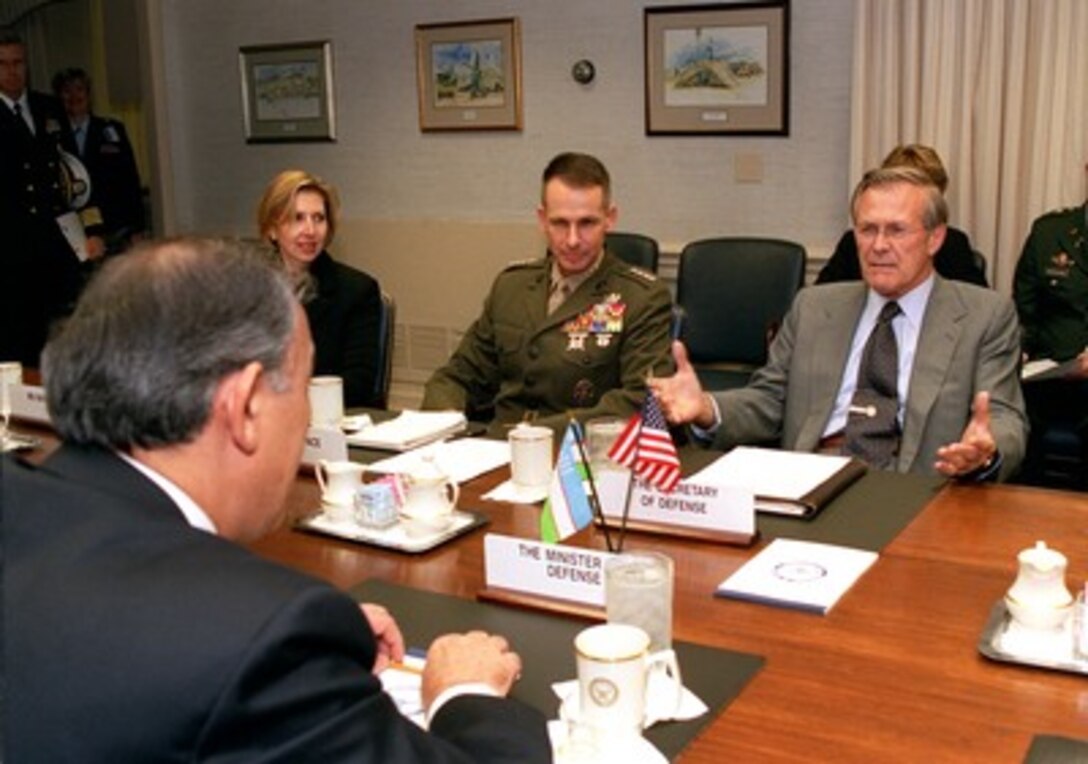 Secretary of Defense Donald H. Rumsfeld (right) meets with Minister of Defense Kodir Ghulomov (left foreground), of Uzbekistan, in the Pentagon on Nov. 30, 2001. The two defense leaders are meeting to discuss a range of bilateral security issues including regional support for the war on terrorism. Deputy Assistant Secretary of Defense for Eurasia Mira Baratta and Vice Chairman of the Joint Chiefs of Staff Gen. Peter Pace, U.S. Marine Corps, joined Rumsfeld and Ghulomov in the talks. 