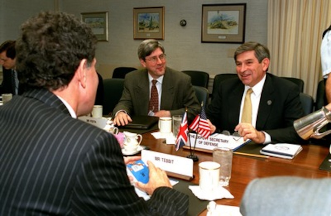 Deputy Secretary of Defense Paul Wolfowitz (right) meets with Permanent Under Secretary of the British Ministry of Defence Kevin Tebbit in the Pentagon on Dec. 7, 2001. Wolfowitz and Tebbit are meeting to discuss a range of bilateral security issues. Also participating in the talks is Under Secretary of Defense for Policy Douglas Feith. 