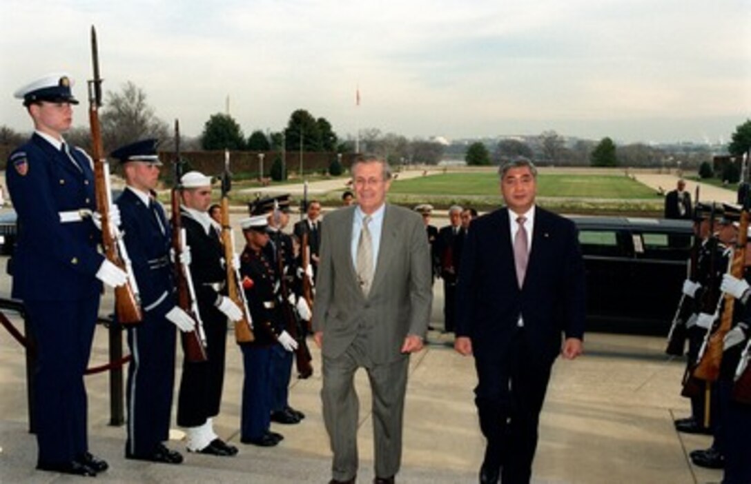Secretary of Defense Donald H. Rumsfeld (left) escorts the Director General of the Japan Defense Agency Gen Nakatani through an honor cordon and into the Pentagon on Dec. 10, 2001. The two leaders will meet to discuss issues of mutual interest to both countries. 