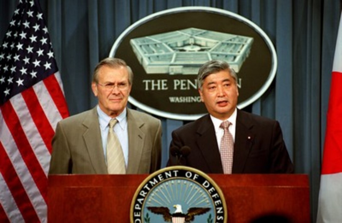 Secretary of Defense Donald H. Rumsfeld (left) listens as the Director General of the Japan Defense Agency Gen Nakatani responds to a reporter's question at a Pentagon joint press availability on Dec. 10, 2001. The two leaders met earlier to discuss issues of mutual interest to both countries. 