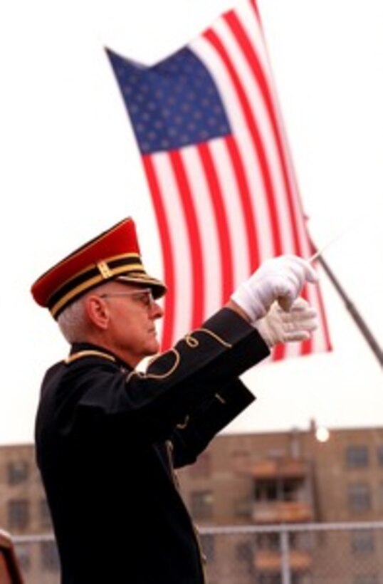 Army Col. Gary F. Lamb conducts the U.S. Army Band (Pershing's Own) in the playing of the National Anthem during a Dec. 11, 2001, Pentagon ceremony in remembrance of those who perished in the terrorist attack on Sept. 11th. Lamb began the anthem at 9:38 a.m., the precise time American Airlines Flight 77 impacted the southwest face of the building killing 184 people. The ceremony is part of a day of remembrance proclaimed by President George W. Bush. 