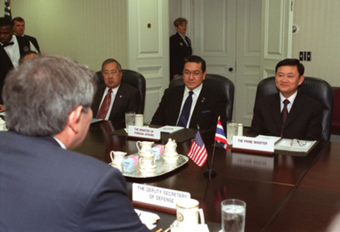 Prime Minister Thaksin Shinawatra (right), of Thailand, meets with Deputy Secretary of Defense Paul Wolfowitz (left-foreground) at the Pentagon on Dec. 13, 2001. Shown seated with the prime minister are Sakthip Krairksh (left), Thailand's ambassador to the United States and Surakiat Sathianthai (center), the minister of foreign affairs. They are discussing a range of bilateral security issues. 