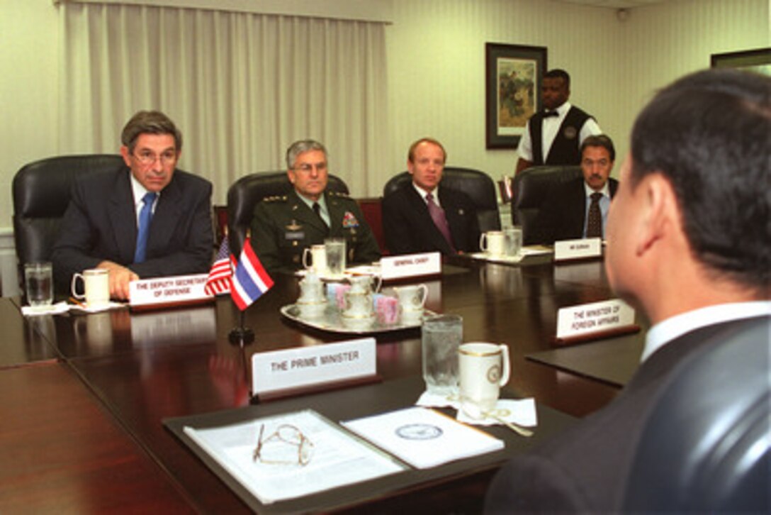 Deputy Secretary of Defense Paul Wolfowitz (left), joined by some of his senior advisors, hosts a Dec. 13, 2001, Pentagon meeting with Prime Minister Thaksin Shinawatra (right-foreground), of Thailand. Under discussion are a range of bilateral security issues. 