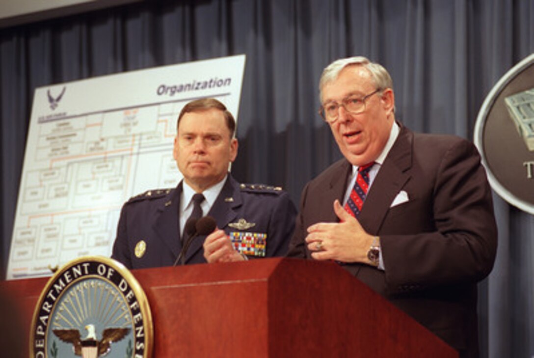 Secretary of the Air Force James Roche, joined by Air Force Chief of Staff Gen. John Jumper (left), briefs Pentagon reporters, Dec. 18, 2001, on the planned reorganization of the Headquarters of the U.S. Air Force. The reorganization effort evolved from three imperatives laid down in a speech made by Secretary of Defense Donald Rumsfeld on the day before the Sept. 11 terrorist attacks against the United States. 