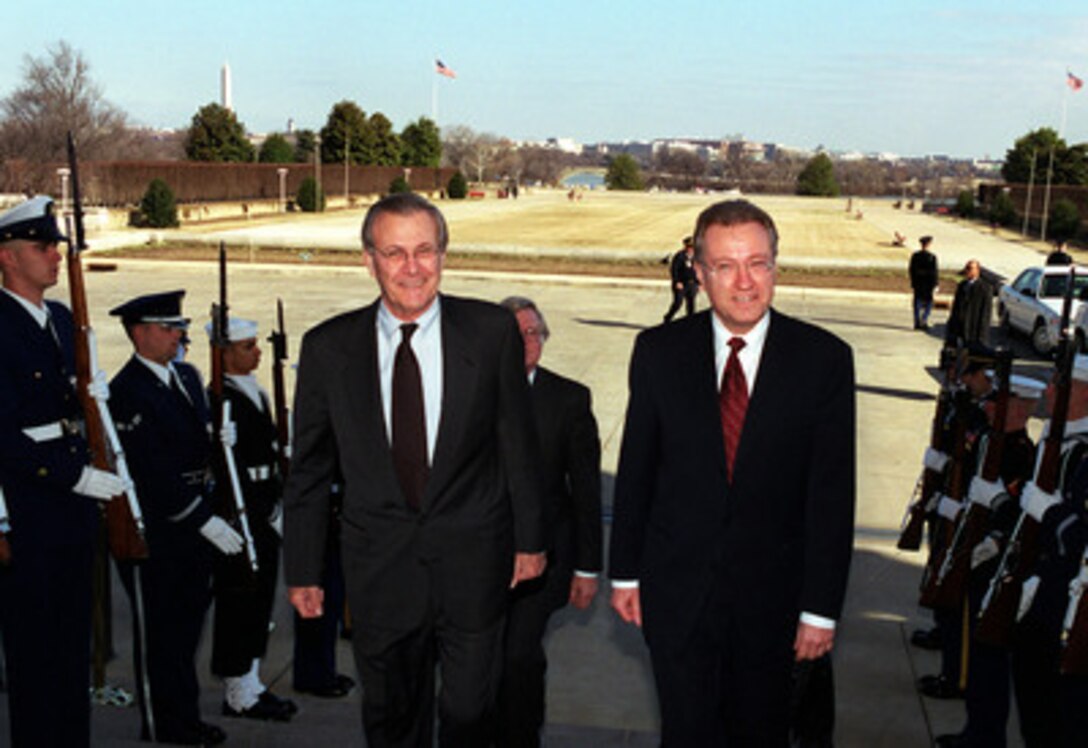 Secretary of Defense Donald H. Rumsfeld (left) escorts Minister of National Defense of Canada Arthur Eggleton (right) into the Pentagon on Feb. 1, 2001. Rumsfeld and Eggleton will meet to discuss national and regional security issues of interest to both nations. 