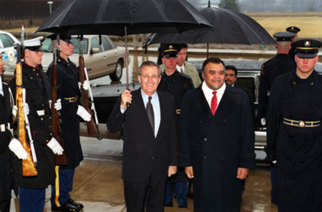Secretary of Defense Donald H. Rumsfeld (left) escorts Prince Bandar Bin Sultan Bin Abdul Aziz (right), the ambassador of the Kingdom of Saudi Arabia to the U.S, through an honor cordon and into the Pentagon for a meeting on Feb. 5, 2001. 