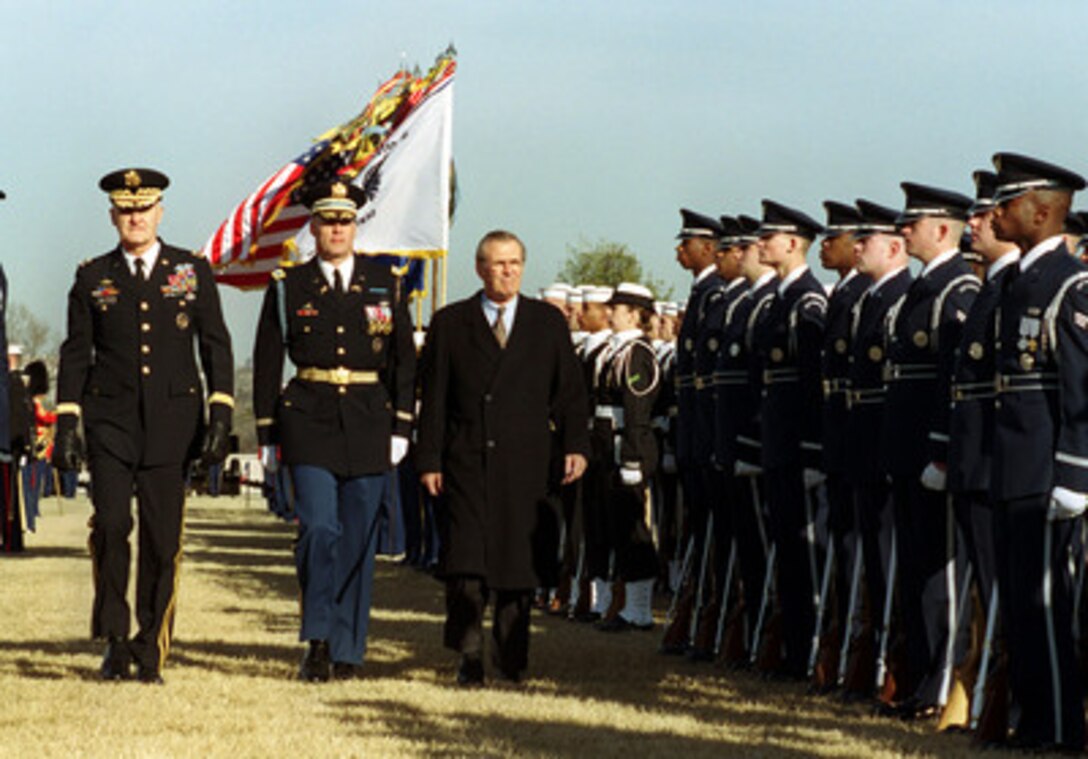 Secretary of Defense Donald H. Rumsfeld (right) is escorted by Commander of Troops Col. Thomas M. Jordan (center), U.S. Army, and Chairman of the Joint Chiefs of Staff Gen. Henry H. Shelton, U.S. Army, as he inspects the troops at an Armed Forces Full Honor Welcoming Ceremony and Review in his honor at the Pentagon parade field on Jan. 26, 2001. Rumsfeld was sworn in as the 21st secretary of Defense in a ceremony at the White House Oval Office earlier today. 