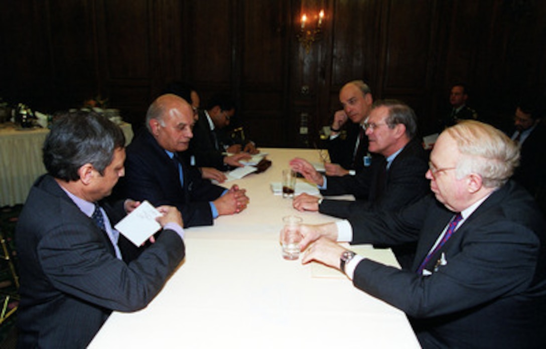 Secretary of Defense Donald H. Rumsfeld (second from right) and his staff meet with Brajesh Mishra (second from left), National Security Advisor of the Republic of India, and his staff during the 37th Munich Conference on Security Policy Feb. 3, 2001. Rumsfeld is flanked by Assistant Secretary of Defense International Security Affairs Franklin D. Kramer (far side), and William Schneider Jr., Assistant to the Secretary of Defense. 