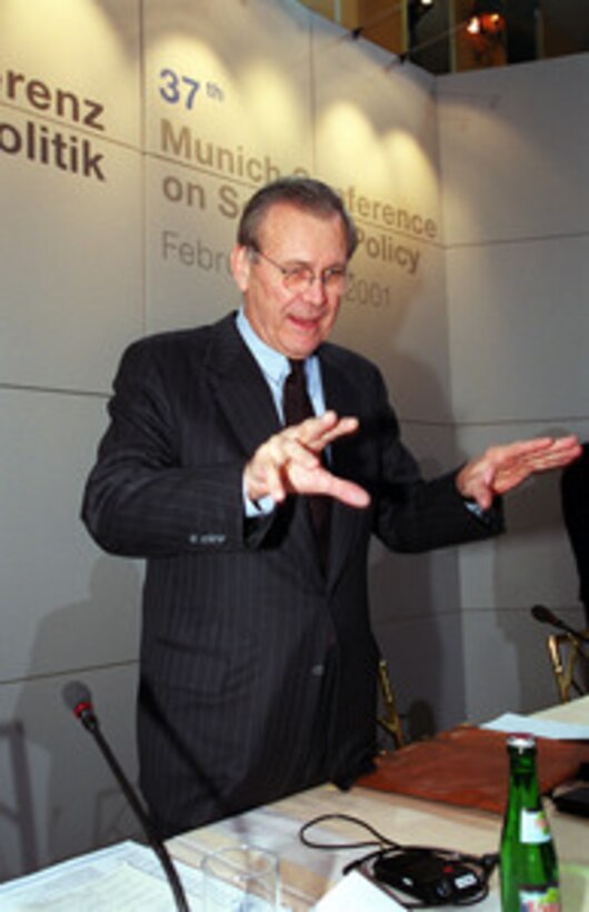 Secretary of Defense Donald H. Rumsfeld talks with colleagues prior to delivering his address at the 37th Munich Conference on Security Policy Feb. 3, 2001. 