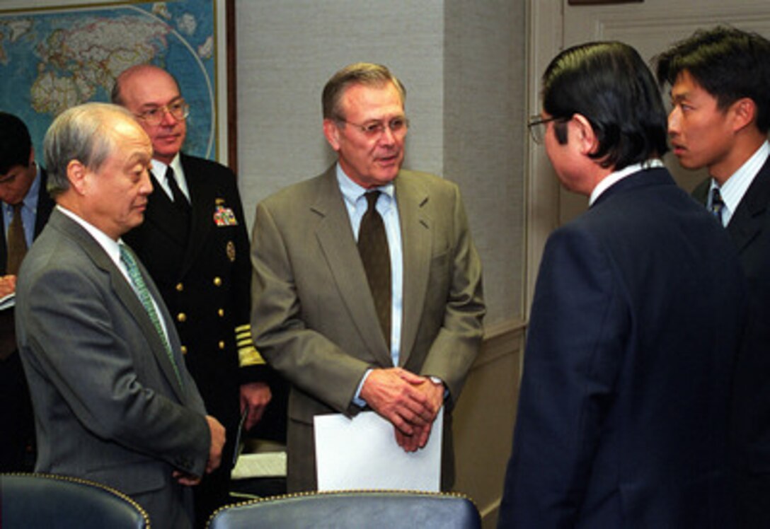 Secretary of Defense Donald H. Rumsfeld (center) talks to Japanese Senior Vice Minister of Foreign Affairs Seishiro Eto (right) during a brief meeting in the Pentagon on Feb. 16, 2001. Ambassador to the U.S. Shunji Yanai (left) and Chief of Naval Operations Vern Clark, U.S. Navy, joined Rumsfeld and Eto in the meeting to discuss the February 9th collision of the submarine USS Greeneville and the Japanese fishing vessel Ehime Maru. 