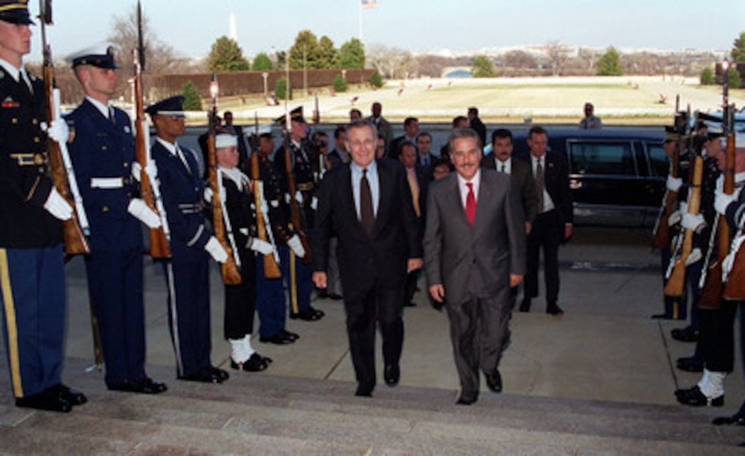 Secretary of Defense Donald H. Rumsfeld (left) escorts President Andres Pastrana, of Colombia, through an honor cordon and into the Pentagon for a meeting on Feb. 26, 2001. The two men will discuss a range of regional issues of interest to both nations. 