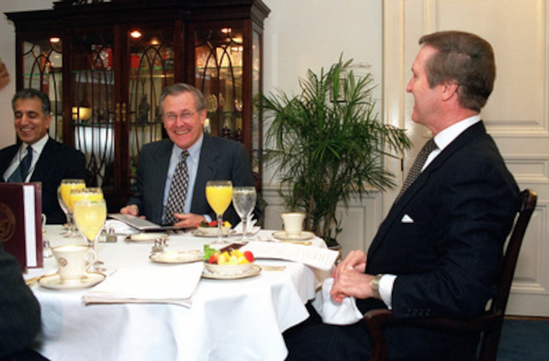 Secretary of Defense William S. Cohen (right), Secretary of Defense-designate Donald H. Rumsfeld (center) and DoD Transition Team Chief Zalmay M. Khalilzad (left) meet in Cohen's Pentagon office for a working breakfast on Jan. 5, 2001. Cohen and Rumsfeld are meeting to discuss defense issues and the transition. 