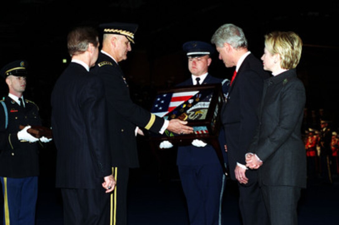 Chairman of the Joint Chiefs of Staff Gen. Henry H. Shelton, U.S. Army, presents a departure gift to President Bill Clinton in a ceremonial farewell at Fort Myer, Va., on Jan. 5, 2001. Shelton and Secretary of Defense William S. Cohen are hosting the Armed Forces Review and Awards Ceremony in honor of the president and First Lady Hillary Rodham Clinton. 