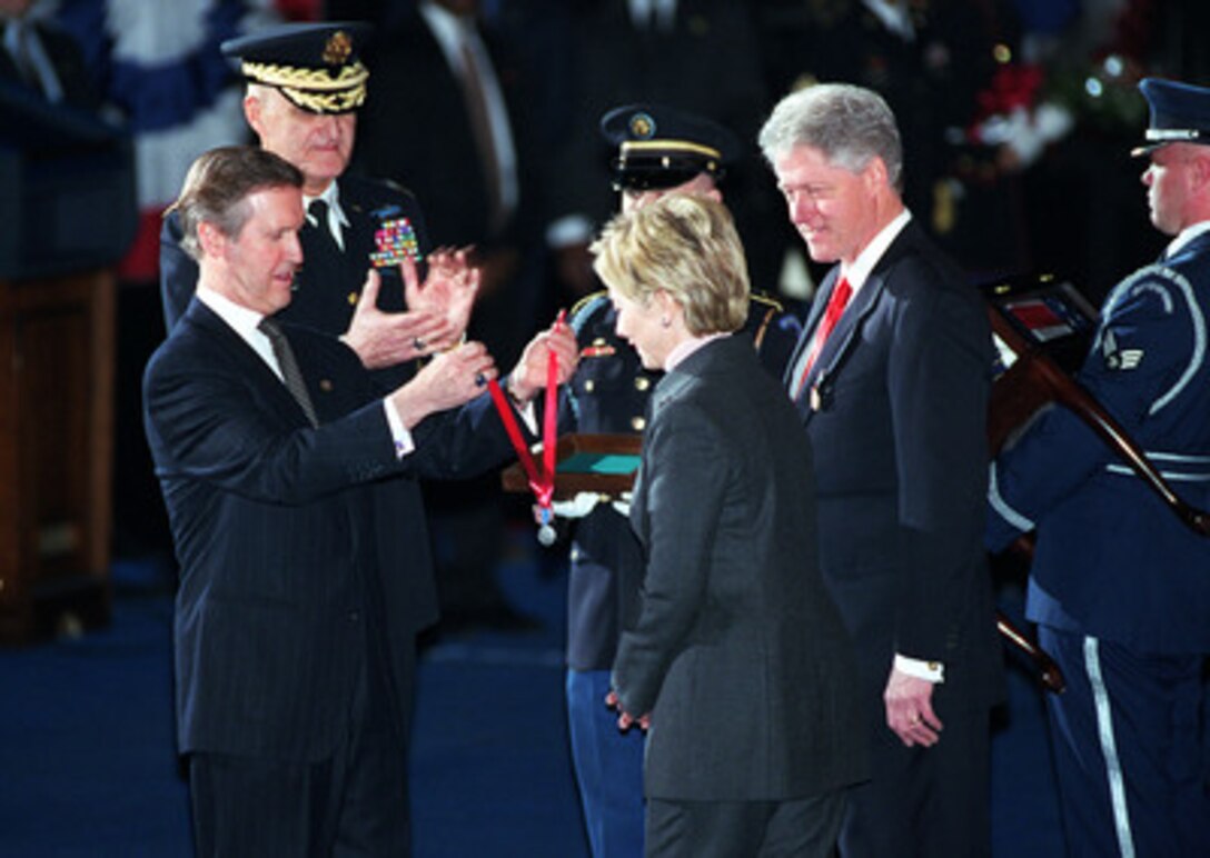 Secretary of Defense William S. Cohen presents the Secretary of Defense Medal for Outstanding Public Service to First Lady Hillary Rodham Clinton as President Bill Clinton watches during a ceremonial farewell at Fort Myer, Va., on Jan. 5, 2001. Cohen and Chairman of the Joint Chiefs of Staff Gen. Henry H. Shelton (left), U.S. Army, are hosting the Armed Forces Review and Awards Ceremony in honor of the president and first lady. 