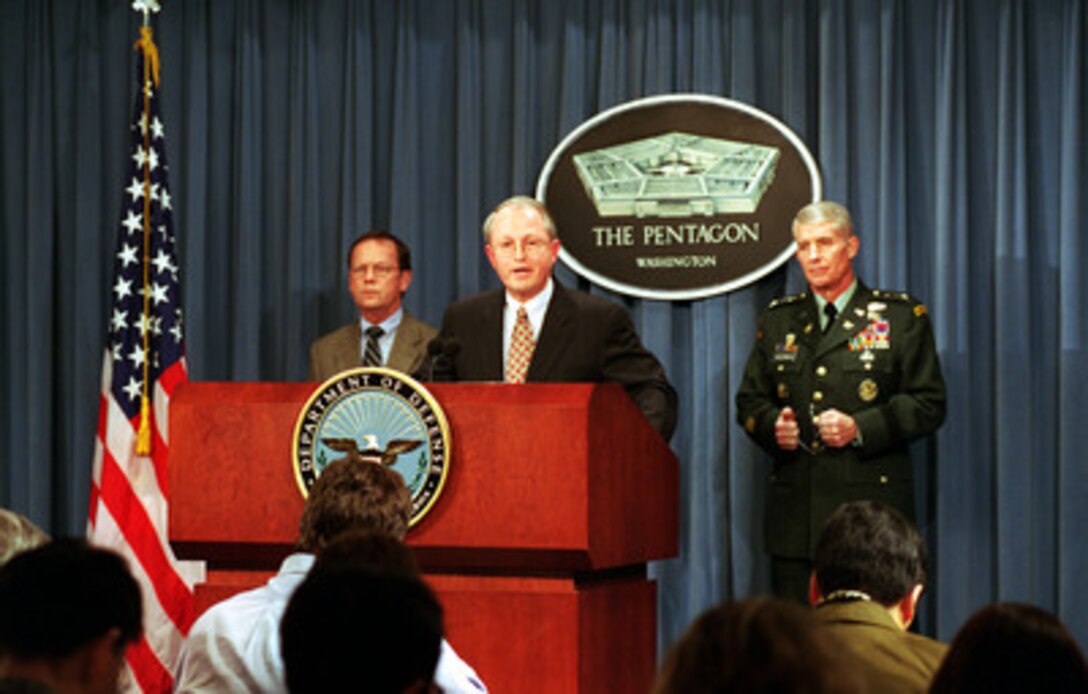 Principal Deputy Assistant Secretary of Defense for Reserve Affairs Charles L. Cragin, (center) briefs reporters in the Pentagon on Jan. 11, 2001, about the collaborative efforts between the U.S. and Republic of Korea to describe what happened at No Gun Ri during late June 1950. Assistant Secretary of the Army for Manpower and Reserve Affairs Patrick T. Henry (left) and Inspector General of the Army Lt. Gen. Michael W. Ackerman (right) joined Cragin for the briefing. 