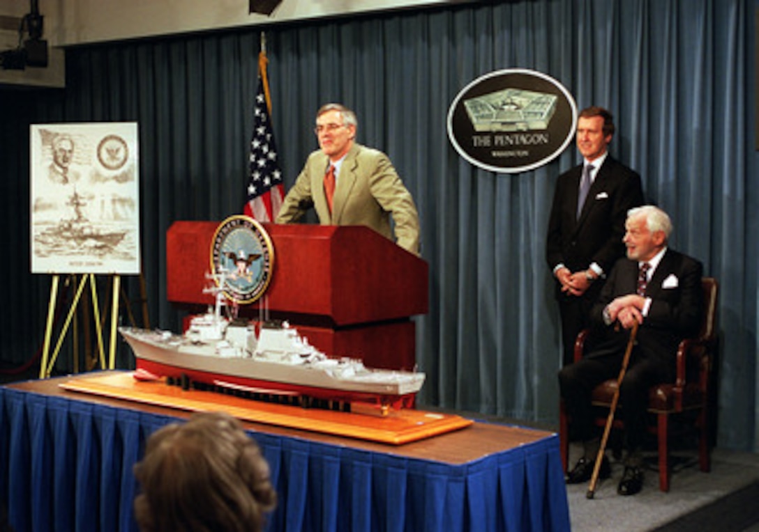 Secretary of the Navy Richard Danzig (left) announces at a Pentagon press conference on Jan. 10, 2001, that a new Arleigh Burke-class guided missile destroyer will be named in honor of famed defense policy and arms control expert Paul H. Nitze (seated right). Secretary of Defense William S. Cohen (center) joined Danzig at the announcement. The USS Nitze (DDG-94), which is due to join the fleet in 2004, is a multi-mission ship equipped with the Navy's AEGIS combat weapons system, which combines space-age communications, radar and weapons technologies into a single platform for maximum flexibility. The ship will be capable of firing surface-to-air missiles and Tomahawk cruise missiles as well as torpedoes and is equipped with a five-inch gun. The ship will also carry dual embarked SH-60 helicopters. 
