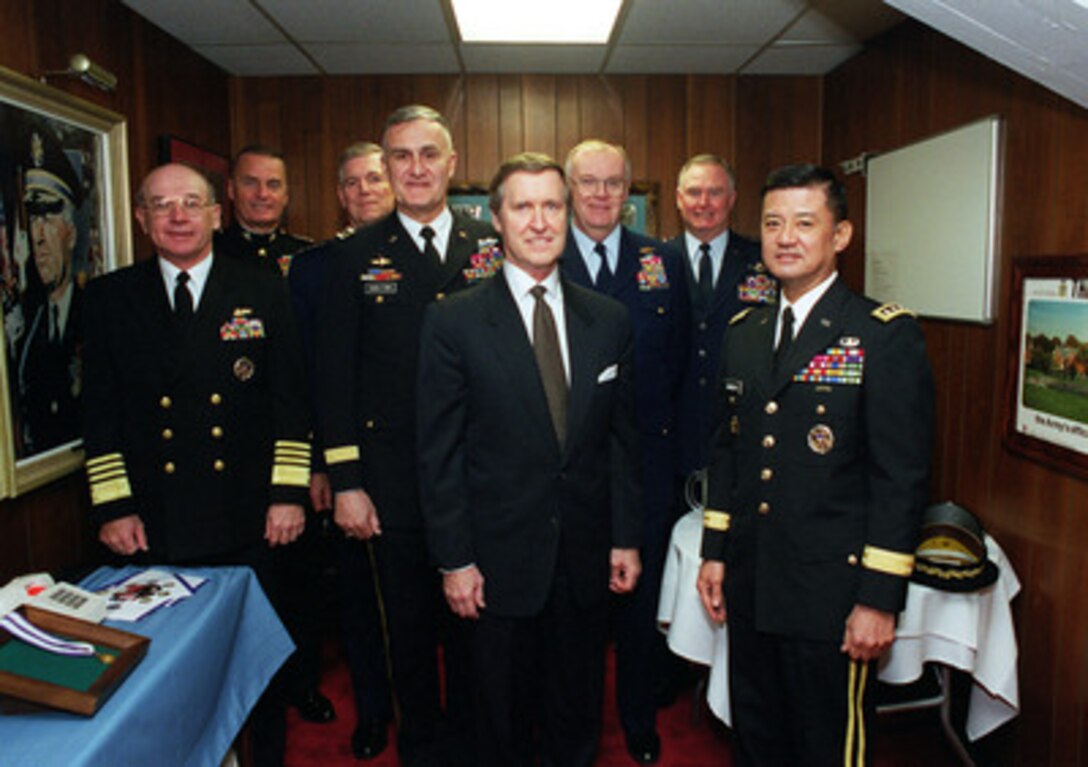 Secretary of Defense William S. Cohen (center) poses for an informal group photo with the Joint Chiefs of Staff and the Commandant of the Coast Guard before his farewell ceremony at Conmy Hall, Fort Myer, Va., on Jan. 17, 2001. From left to right are: Chief of Naval Operations Adm. Vern Clark, Commandant of the Marine Corps Gen. James Jones, Vice Chairman of the Joint Chiefs of Staff Gen. Richard Myers, U.S. Air Force; Chairman of the Joint Chiefs of Staff Gen. Henry H. Shelton, U.S. Army, Cohen, Commandant of the Coast Guard Adm. James Loy, Chief of Staff of the Air Force Gen. Michael Ryan, and Chief of Staff of the Army Gen. Eric Shinseki. 