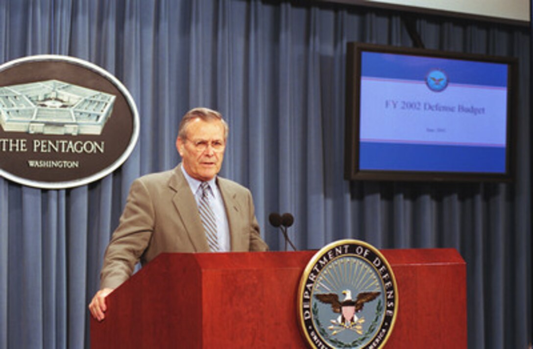 Secretary of Defense Donald H. Rumsfeld listens to a question posed by a reporter during a briefing by Under Secretary of Defense (Comptroller) Dov Zakheim on the Bush Administration's amended fiscal 2002 budget request for the Department of Defense June 27, 2001. 