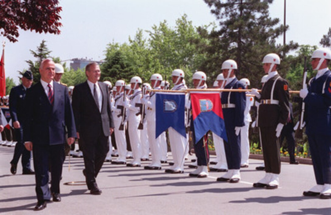 Secretary of Defense Donald H. Rumsfeld (right) is welcomed to the Turkish Defense Forces General Staff Headquarters in Ankara, Turkey, June 4, 2001, with a full honor arrival ceremony hosted by Minister of Defense Sabahattin Cakmakoglu (left). Rumsfeld is visiting Turkey as the first stop on a planned seven-day, seven-nation tour to solidify relations with our European allies and to visit U.S. troops stationed in the region. 