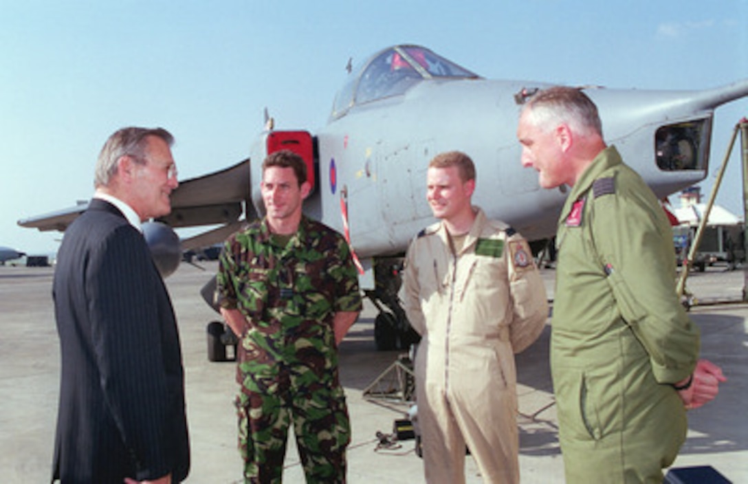 Secretary of Defense Donald H. Rumsfeld (left) talks with two pilots and a support technician from the British Royal Air Force SEPCAT Jaguar unit assigned to Incirlik Air Base, Turkey, as part of the Combined Task Force Operation Northern Watch. As with the Turkish, and U.S. Air Force F-16s flying out of Incirlik, the British Jaguar fighter-bombers regularly participate in patrols over northern Iraq to enforce the no-fly zone. Rumsfeld stopped at Incirlik on June 4, 2001, after having spent the morning in meetings with senior officials of the Turkish Government in Ankara, the nation's capitol. Turkey was Rumsfeld's first stop in a planned seven-day, seven-nation European tour. 