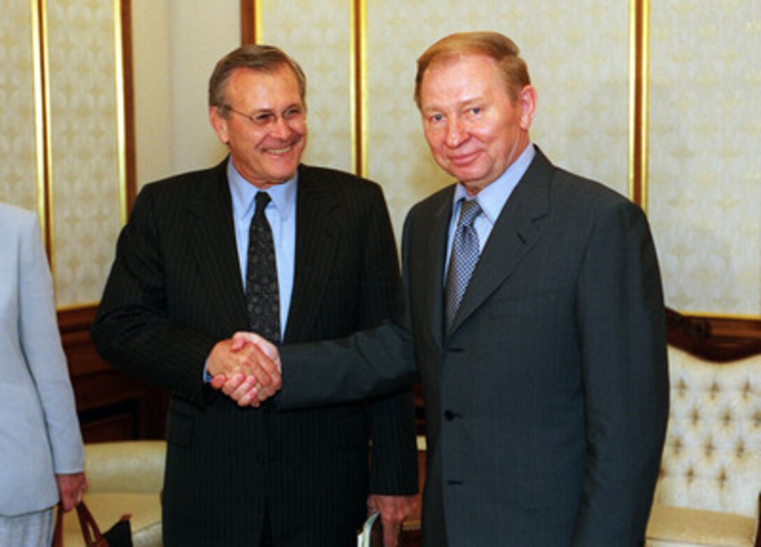 Secretary of Defense Donald H. Rumsfeld (left) and Ukrainian President Leonid Kuchma (right) pose for photographers in Kuchma's office in Kiev, Ukraine, on June 5, 2001. The two men will meet to discuss a range of security issues of interest to both nations. Kiev is Rumsfeld's second stop on a seven-day, seven-nation, European tour. 