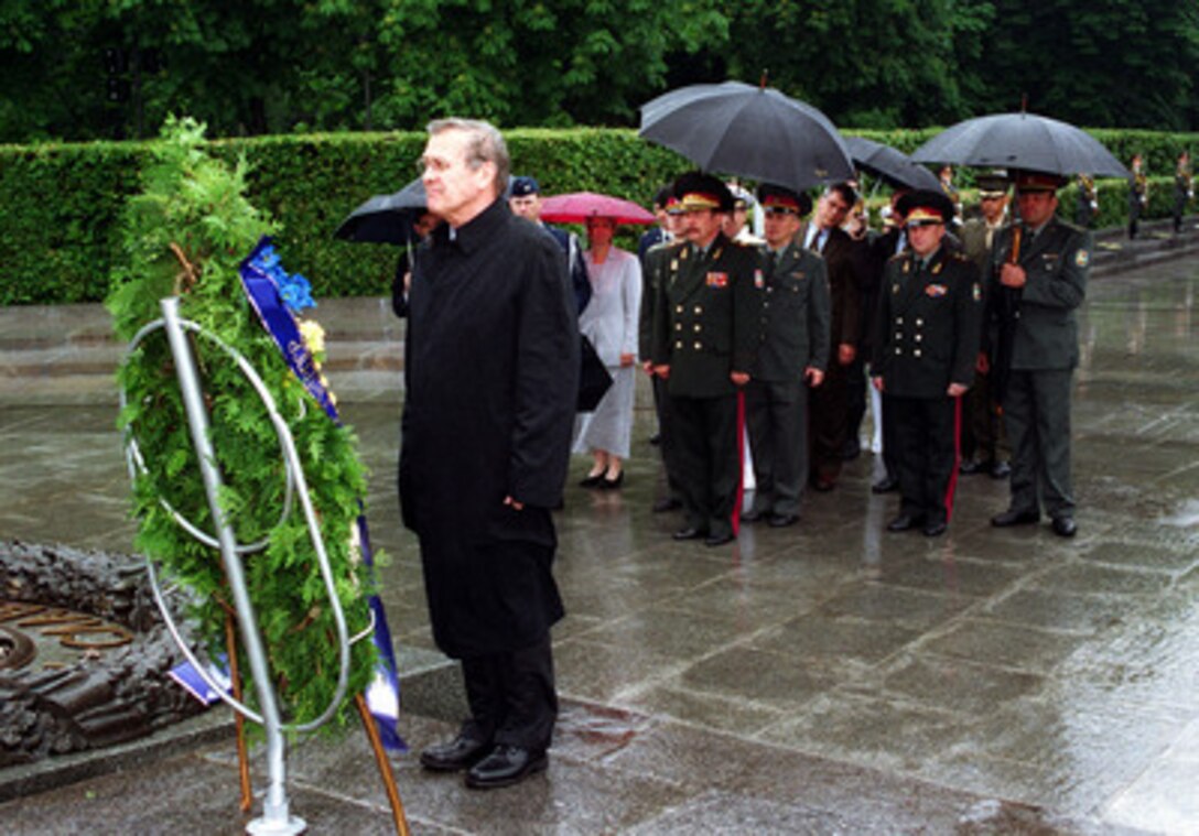 Secretary of Defense Donald H. Rumsfeld places a wreath at the War Memorial in Kiev, Ukraine, on June 5, 2001. Rumsfeld is visiting Kiev to meet with his counterpart Ukrainian Minister of Defense Gen. Oleksander Kuzmuk (center) during the second stop of a seven-day, seven-nation, European tour. 