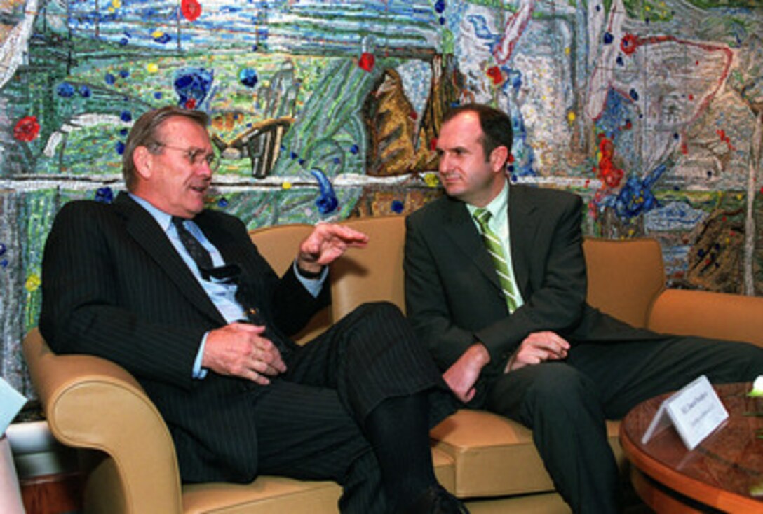 Secretary of Defense Donald H. Rumsfeld (left) discusses regional security issues with Minister of Defense Vlado Buckovski (right) at the international airport in Skopje, capitol of the Former Yugoslav Republic of Macedonia, on June 5, 2001. Rumsfeld is visiting Skopje and the nearby Serbian province of Kosovo as part of a seven-day, seven-nation, European tour. 