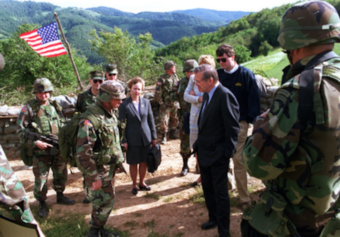 A U.S. Army officer briefs Secretary of Defense Donald H. Rumsfeld as he visits a U.S. observation post in Mijak, Kosovo, Republic of Serbia, on June 5, 2001. The post, because of its close proximity to the Macedonian border, has become increasingly important in recent weeks as fighting between Macedonian government forces and Albanian rebel militias has intensified. The U.S. troops in Mijak regularly patrol the area attempting to prevent shipments of arms from crossing the border into Macedonia. The 31-man U.S. Army unit currently occupying the hilltop is from the 2nd Battalion, 502nd Infantry, 101st Airborne (Air Assault) Division. Rumsfeld is visiting Kosovo as part of a seven-day, seven-nation, European tour. 