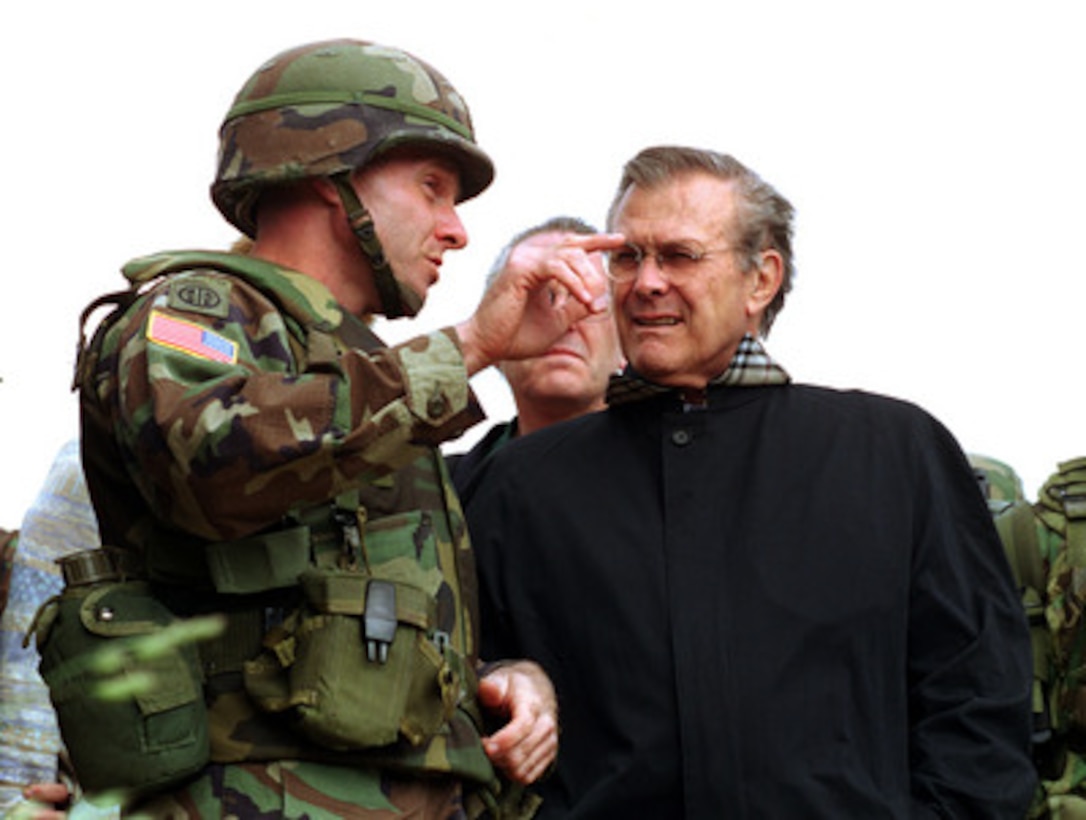 Army Lt. Col. Brian Owens (left) briefs Secretary of Defense Donald H. Rumsfeld on June 5, 2001, about some of the military engagements which have occurred near a U.S. observation post in Mijak, Kosovo, Republic of Serbia. The post, because of its close proximity to the Macedonian border, has become increasingly important in recent weeks as fighting between Macedonian government forces and Albanian rebel militias has intensified. The U.S. troops in Mijak regularly patrol the area attempting to prevent shipments of arms from crossing the border into Macedonia. The 31-man U.S. Army unit currently occupying the hilltop is from the 2nd Battalion, 502nd Infantry, 101st Airborne (Air Assault) Division. Owens is attached to the 1st Battalion, 325th Airborne Infantry Regiment, 82nd Airborne Division. Rumsfeld is visiting Kosovo as part of a seven-day, seven-nation, European tour. 