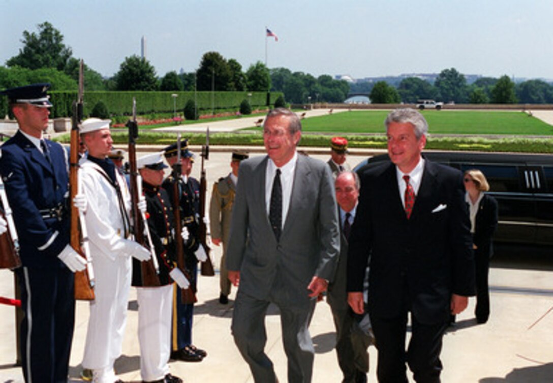 Secretary of Defense Donald H. Rumsfeld (left) escorts French Minister of Defense Alain Richard (right) into the Pentagon on July 9, 2001. The two leaders are meeting to discuss defense issues of interest to both nations. 