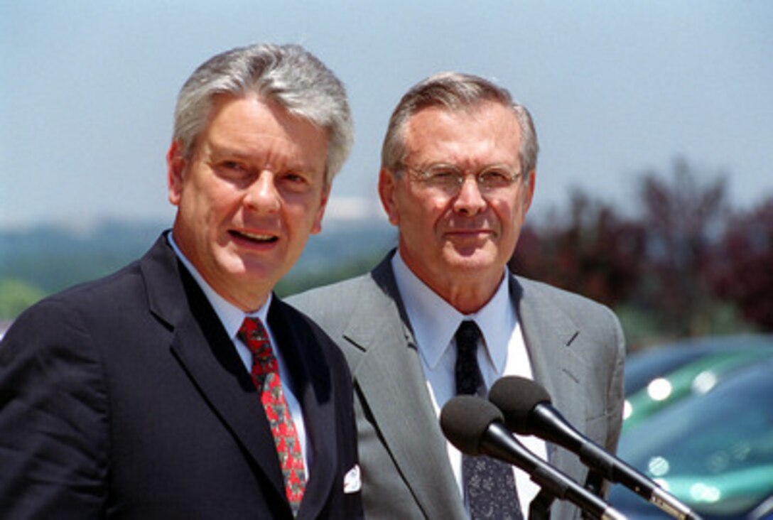 French Minister of Defense Alain Richard (left) makes opening comments during a joint media availability with Secretary of Defense Donald H. Rumsfeld (right) at the Pentagon on July 9, 2001. Richard and Rumsfeld met earlier to discuss defense issues of interest to both nations. 
