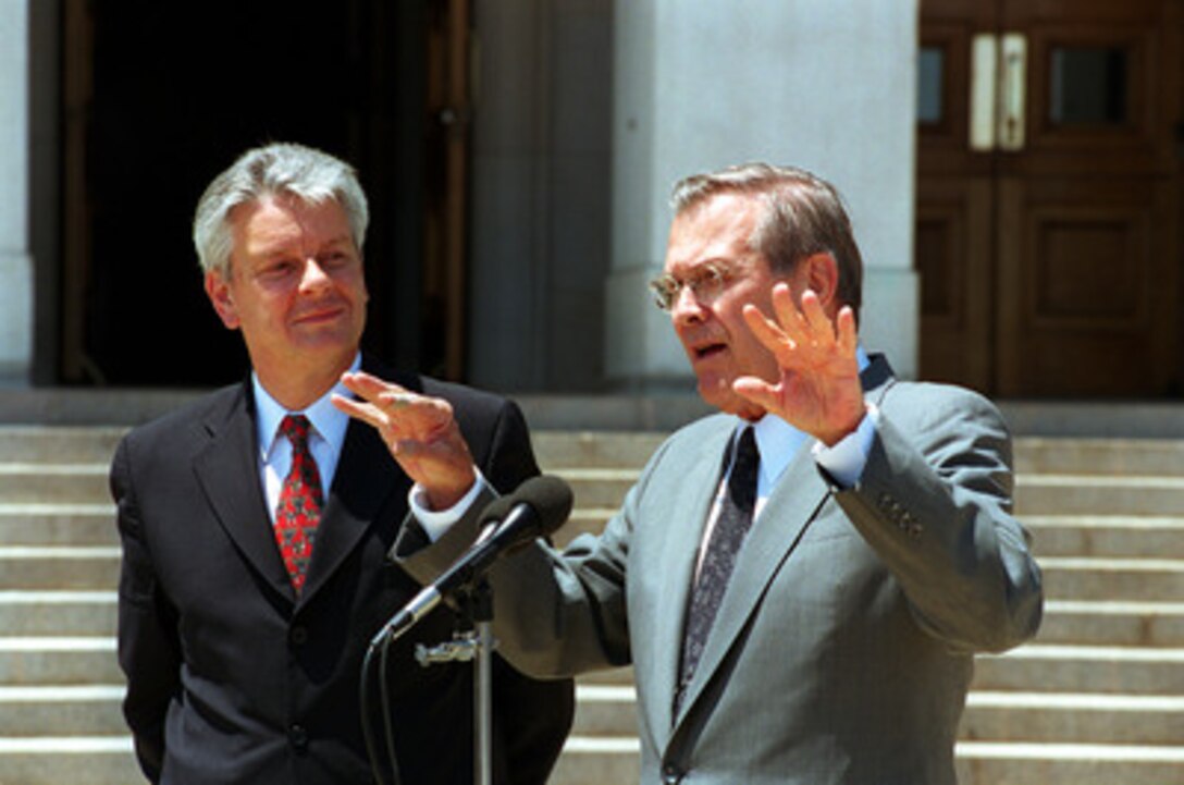 Secretary of Defense Donald H. Rumsfeld (right) responds to a reporter's question during a joint media availability with French Minister of Defense Alain Richard (left) at the Pentagon on July 9, 2001. Richard and Rumsfeld met earlier to discuss defense issues of interest to both nations. 