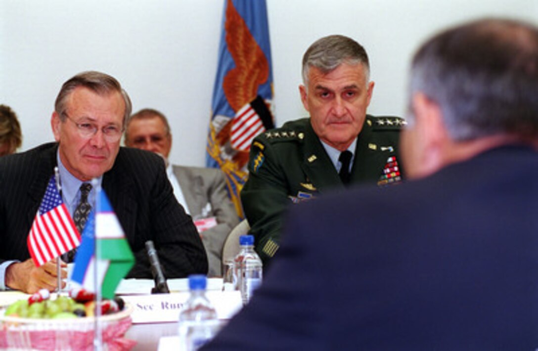Secretary of Defense Donald H. Rumsfeld (left) and Chairman of the Joint Chiefs of Staff Gen. Henry H. Shelton (center), U.S. Army, participate in bilateral security discussions with Minister of Defense Kodir Gulomov (right, foreground), of Uzbekistan, at NATO Headquarters in Brussels, Belgium, on June 8, 2001. 