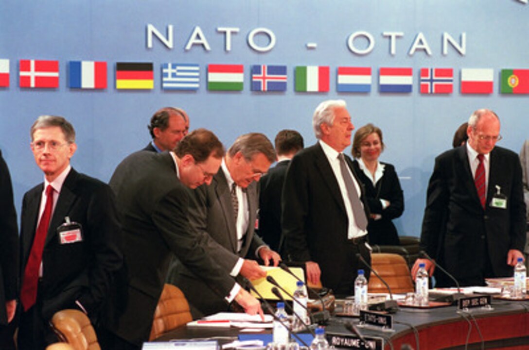 Secretary of Defense Donald H. Rumsfeld (center right) and NATO Ambassador Alexander "Sandy" Vershbow (center left) review some notes before the start of the defense ministerial at NATO Headquarters in Brussels, Belgium, on June 7, 2001. Rumsfeld is one of the most experienced NATO participants having served as NATO ambassador during 1973-74 and as secretary of defense under President Gerald Ford 1975-77. The NATO meeting is one stop of Rumsfeld's seven-day, seven-nation, European tour. 