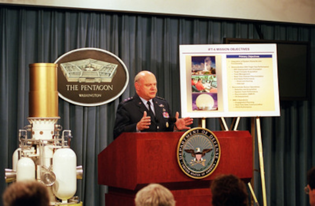 Lt. Gen. Ronald T. Kadish, director of the Ballistic Missile Defense Organization, briefs reporters in the Pentagon on July 15, 2001, on the success of Integrated Flight Test 6, which involved a planned intercept of an intercontinental ballistic missile target. The intercept took place approximately 10 minutes after the interceptor was launched, at an altitude in excess of 140 miles above the earth, and during the midcourse phase of the target warhead's flight. A full scale mock-up of the exoatmospheric kill vehicle is at Kadish's right. 