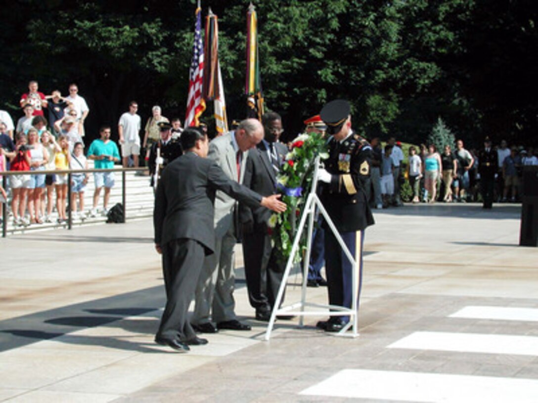 Korean Ambassador Yang Sung Chul (left), Secretary of the Army Thomas White (center), and retired Army Lt. Gen. and Korean War veteran Julius Becton (2nd from right) lay a wreath at the Tomb of the Unknowns at Arlington National Cemetery on July 23, 2001. The wreath laying is part of a Department of Defense commemoration to honor all African-Americans who served in the Korean War. 